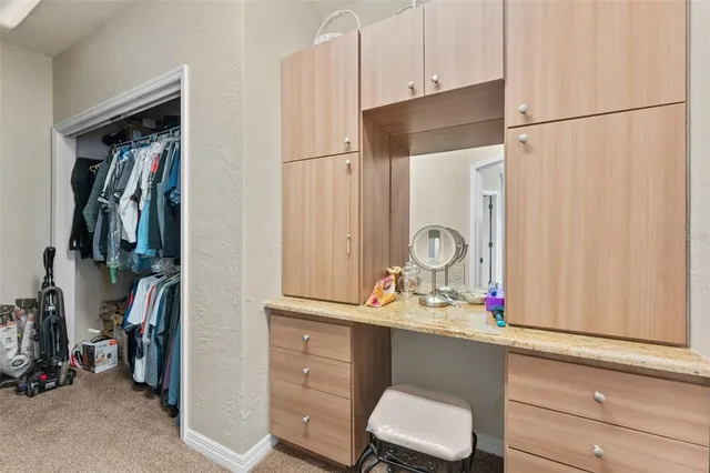 a view of walk in closet with clothes