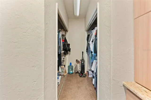 a spacious bedroom with a bed and a chandelier