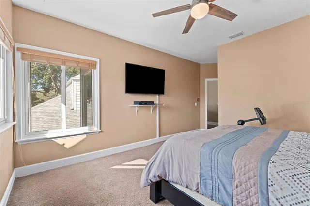 a bathroom with a granite countertop sink a toilet and shower