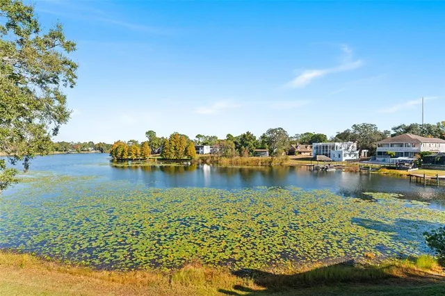 a view of a lake with houses in the back