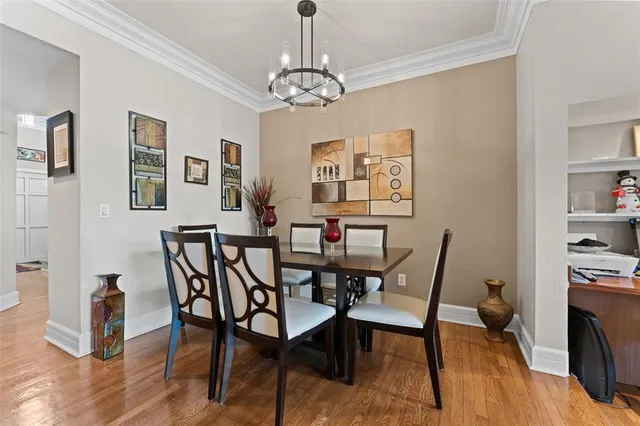 a view of a dining room with furniture wooden floor and a chandelier