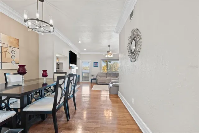 a view of a dining room with furniture and wooden floor