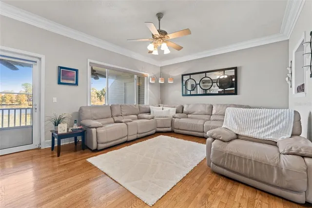 a living room with furniture and a wooden floor
