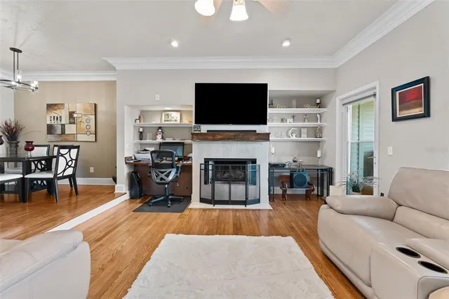 a living room with fireplace furniture and a flat screen tv