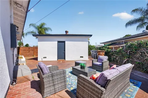 a outdoor living room with furniture and a potted plant