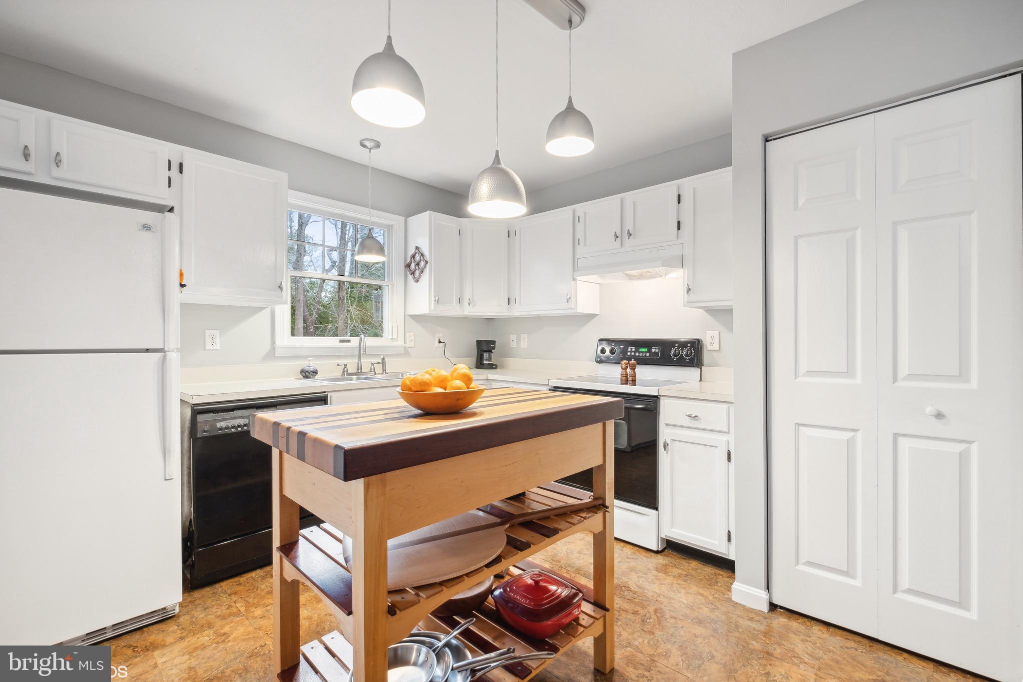 12934 Parran Drive Lusby, MD 20657 - Photo 1 of 21 a kitchen with stainless steel appliances granite countertop a refrigerator sink and white cabinets