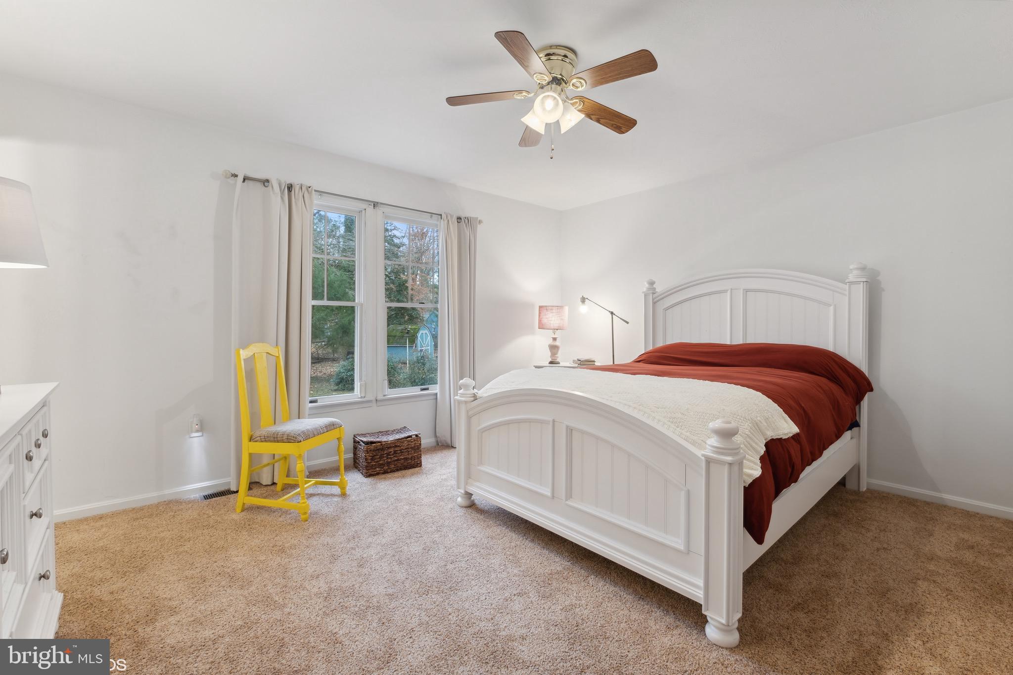 12934 Parran Drive Lusby, MD 20657 - Photo 13 of 21 a bedroom with a bed a chair and a chandelier