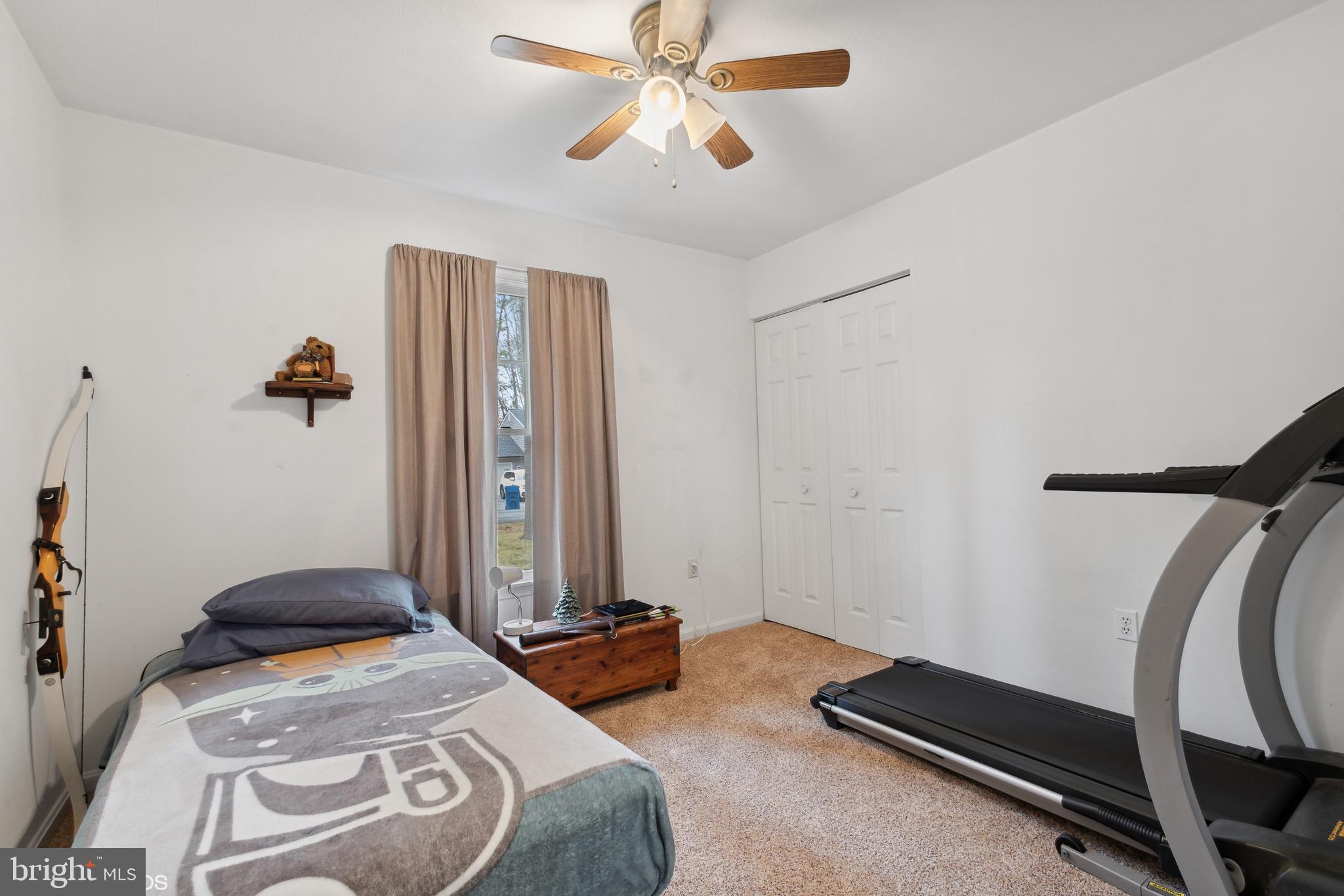 12934 Parran Drive Lusby, MD 20657 - Photo 15 of 21 a bedroom with a bed and a chandelier