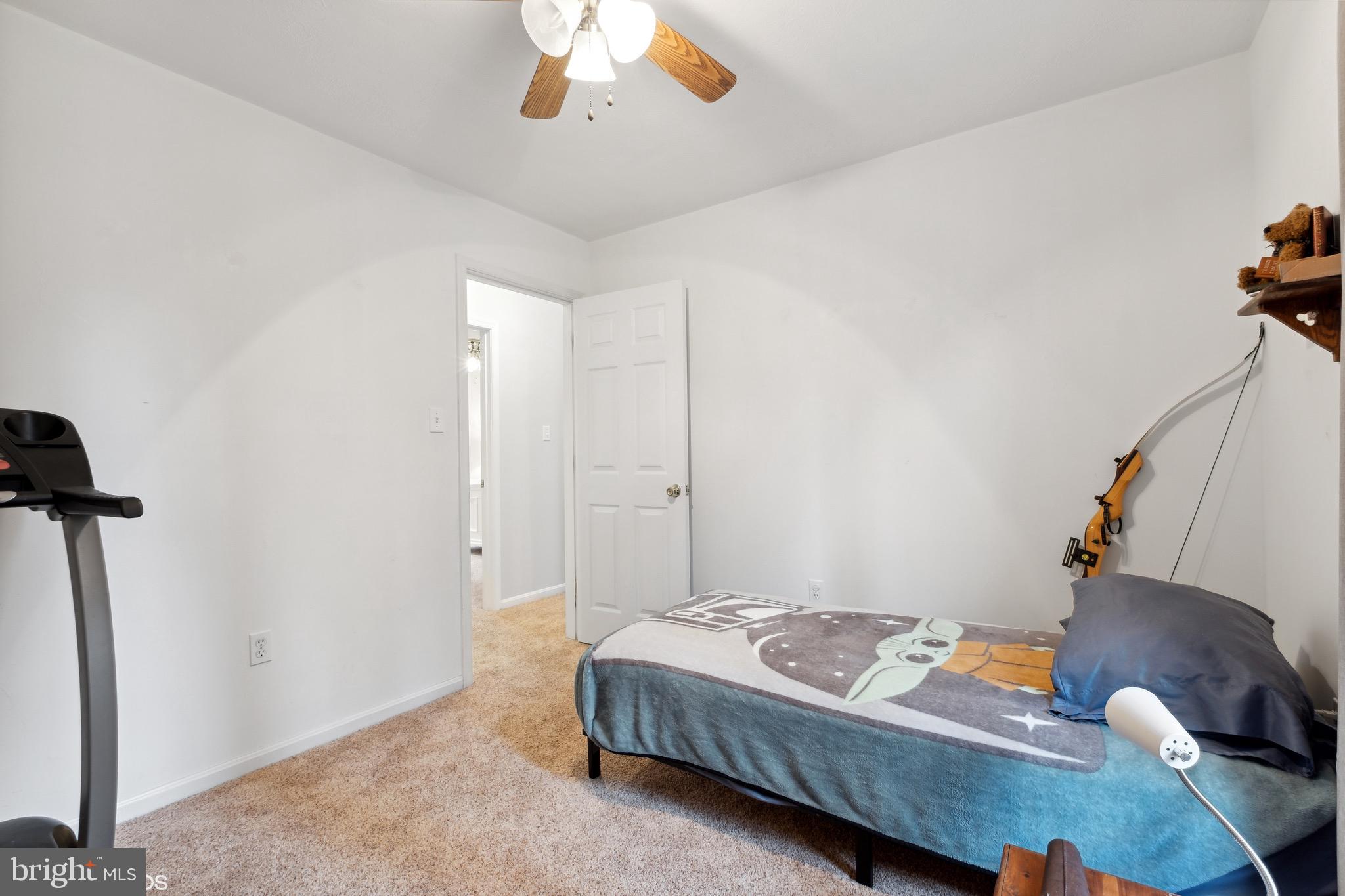 12934 Parran Drive Lusby, MD 20657 - Photo 16 of 21 a bedroom with a bed and a chandelier