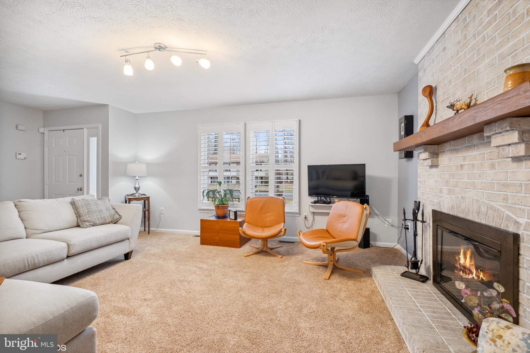 12934 Parran Drive Lusby, MD 20657 - Photo 8 of 21 a living room with furniture and a fireplace