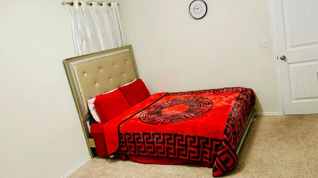 a bedroom with a bed and window