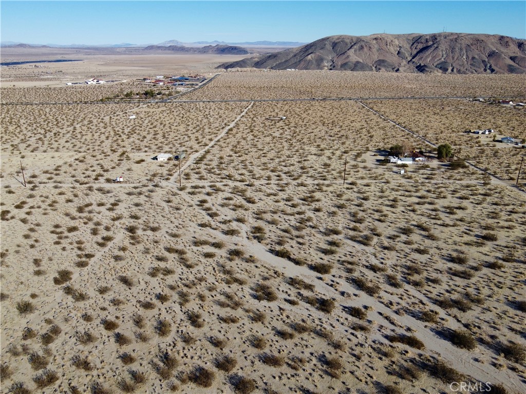 1234 El Rey Avenue Joshua Tree, CA 92252 - Photo 1 of 1 a view of a dry yard with wooden floor and a mountain view