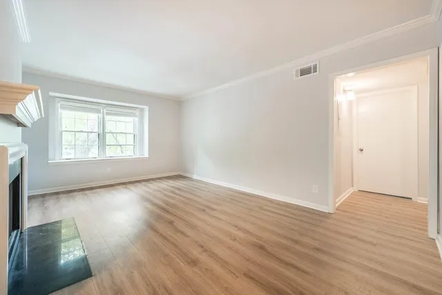 a living room with furniture dining table and a chandelier