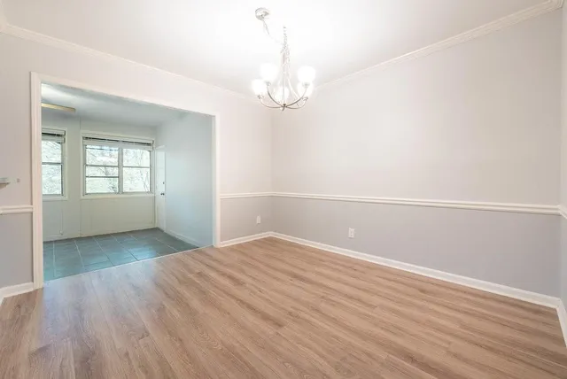 a kitchen with granite countertop a refrigerator and a stove top oven
