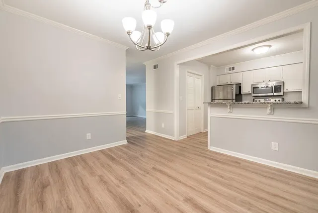 a kitchen with granite countertop a sink and a stove