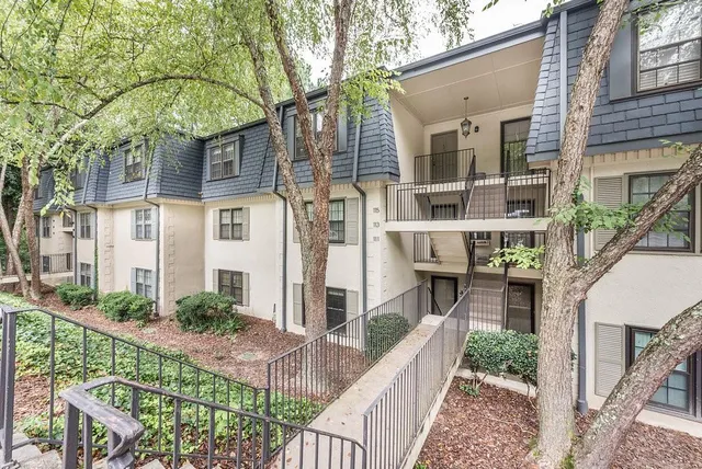 a view of staircase with white walls and a window