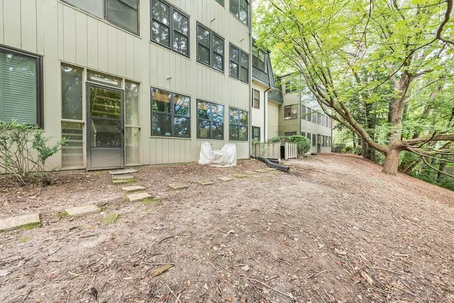 an aerial view of a house with a yard and lake view