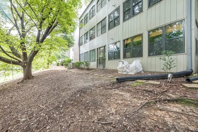 an aerial view of a house with a garden and lake view