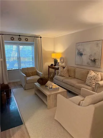 an empty room with wooden floor fireplace and windows