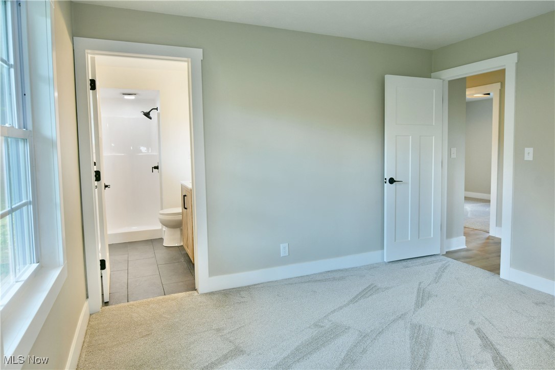 7655 Connelly Road Masury, OH 44438 - Photo 40 of 46 Unfurnished bedroom with carpet, tile patterned floors, and ensuite bathroom
