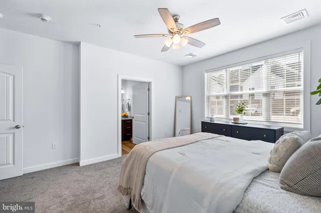 a bedroom with a large bed and a large window