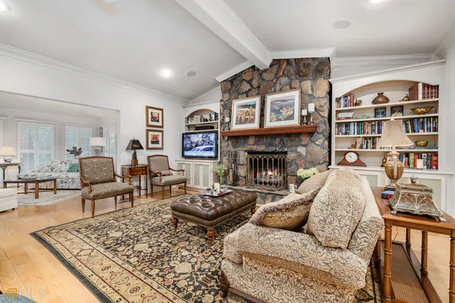 a kitchen with granite countertop stainless steel appliances wooden cabinets a sink and a window