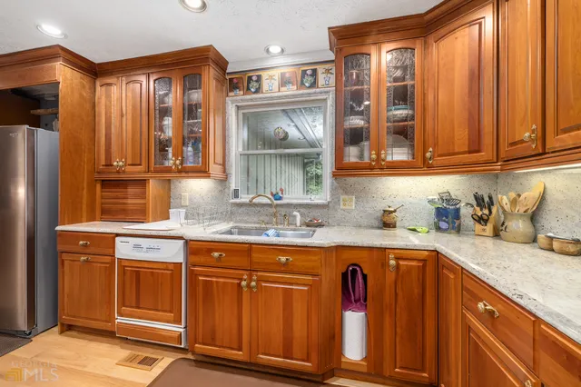 a large white bathroom with a double vanity sink a mirror and a bathtub