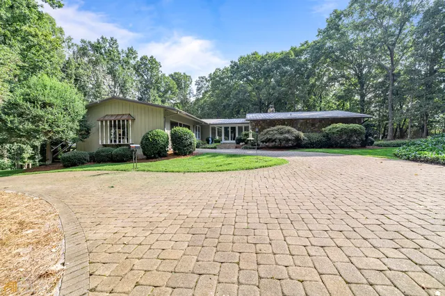 a backyard of a house with lots of green space and garden view