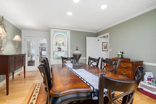 a spacious bedroom with a bed and wooden floor