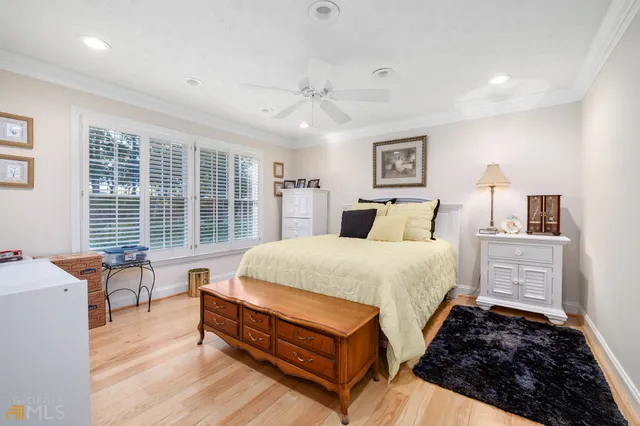 a bedroom with furniture and wooden floor