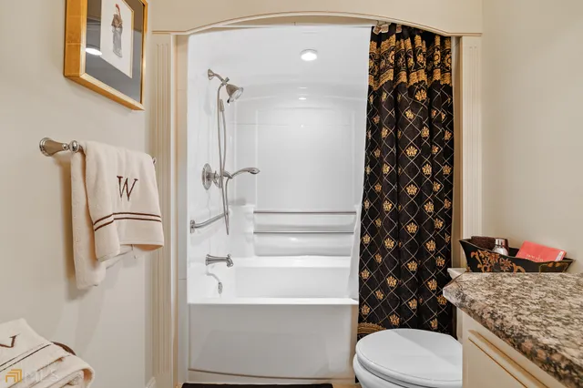 a bathroom with a sink mirror and toilet