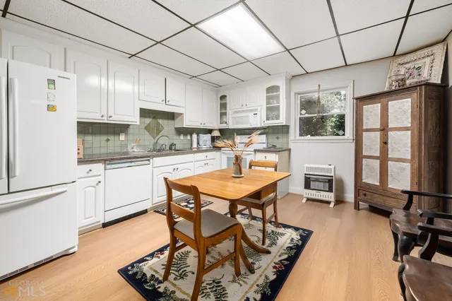 a yellow and red house sitting in middle of a garden