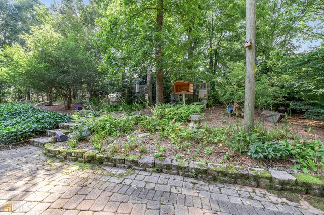 a living room with furniture floor to ceiling window and potted plant
