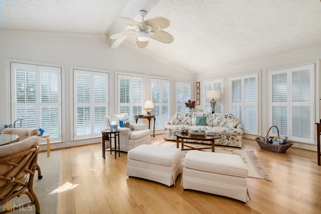 a living room with furniture large window and a fireplace
