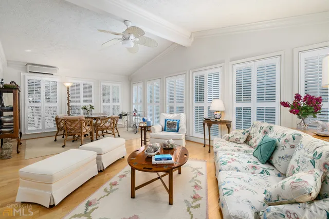 a living room with furniture ceiling fan and a rug