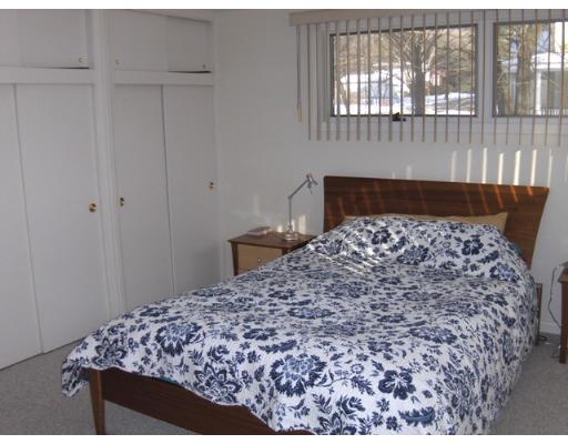23 Tyler Road Lexington, MA 02420 - Photo 8 of 10 a large bed sitting in a bedroom next to a window