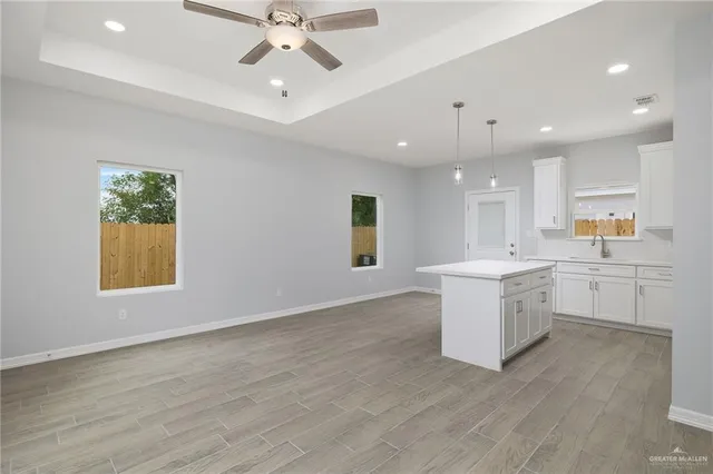 an empty room with a window and wooden floor