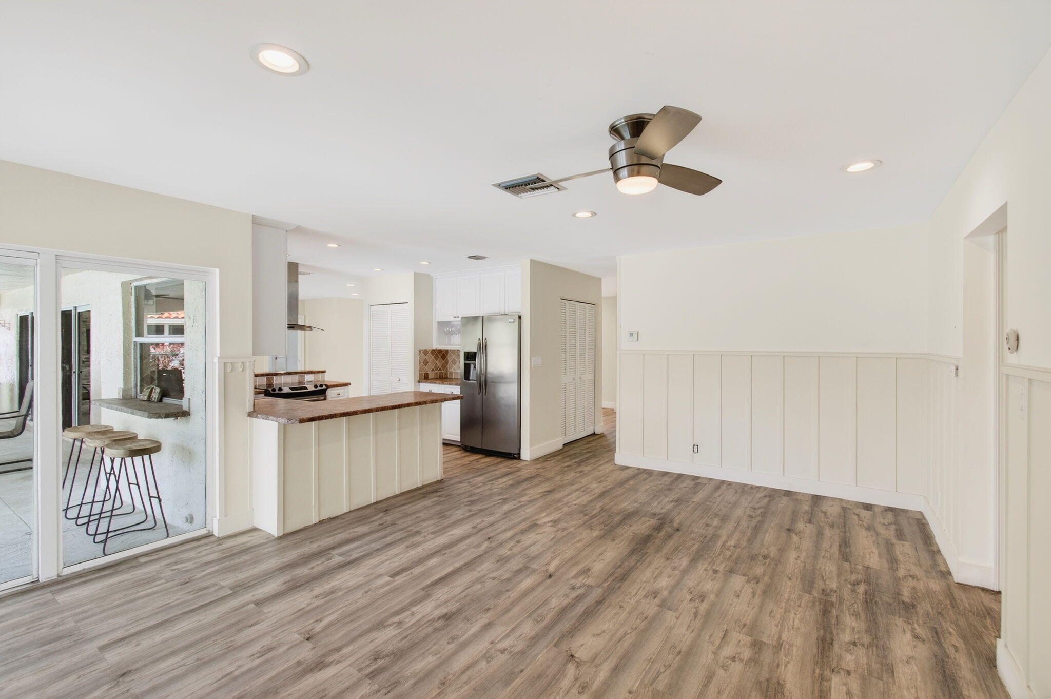 6063 Golf Vista Way Boca Raton, FL 33433 - Photo 11 of 52 a kitchen with a refrigerator and white cabinets