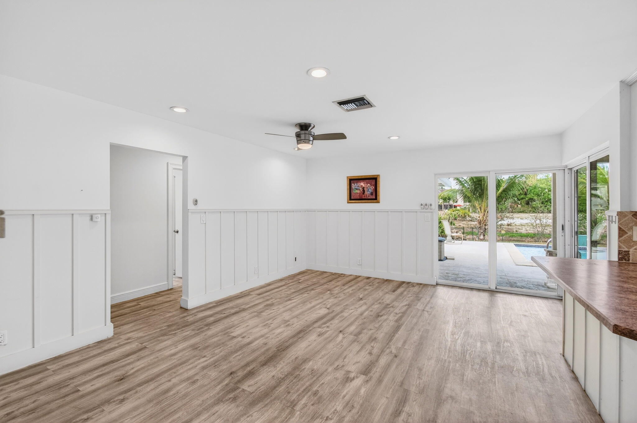 6063 Golf Vista Way Boca Raton, FL 33433 - Photo 12 of 52 wooden floor in an empty room with a window