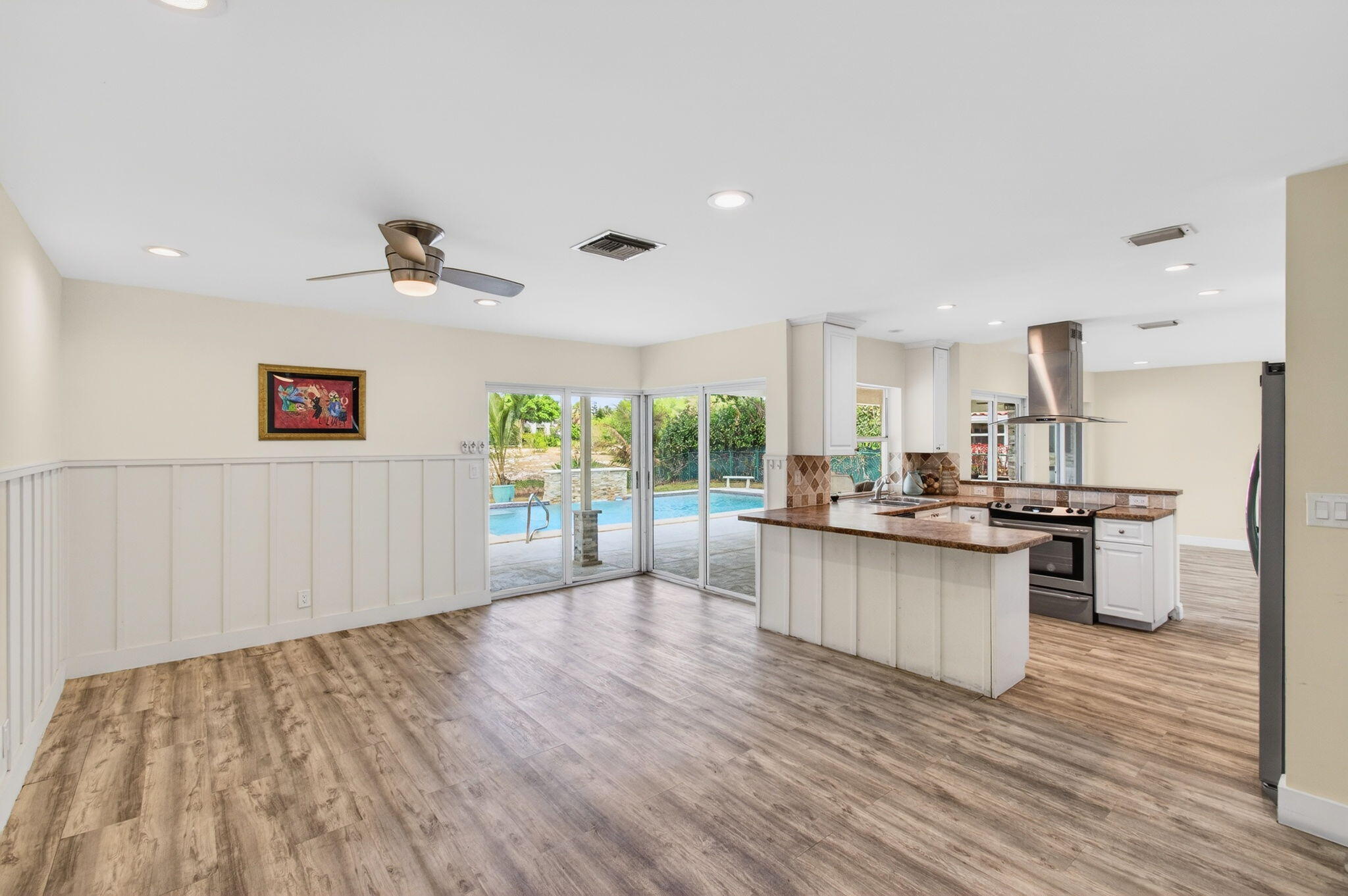 6063 Golf Vista Way Boca Raton, FL 33433 - Photo 13 of 52 a kitchen with stainless steel appliances granite countertop a sink stove and refrigerator