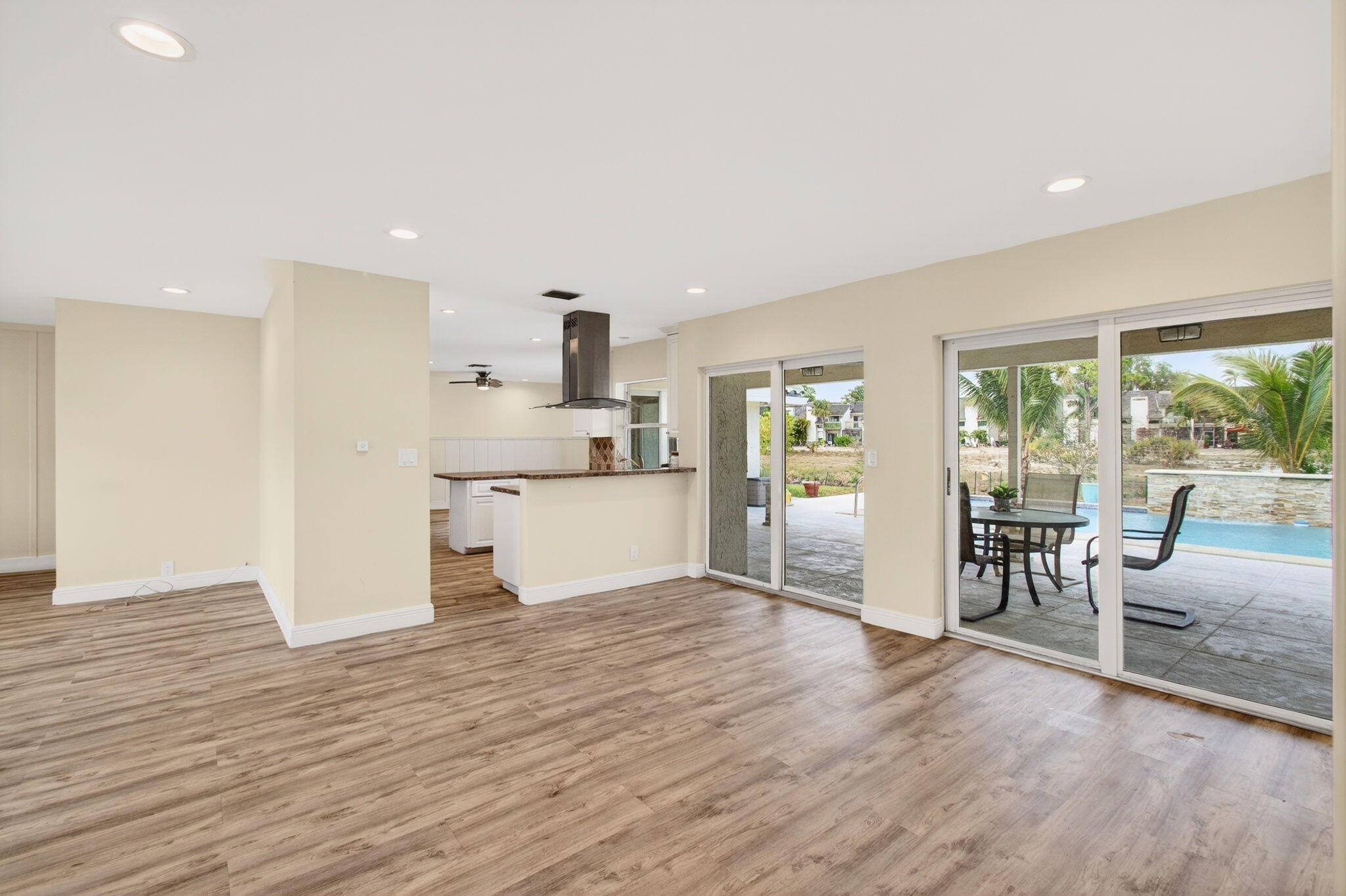 6063 Golf Vista Way Boca Raton, FL 33433 - Photo 14 of 52 a view of empty room with wooden floor and fireplace
