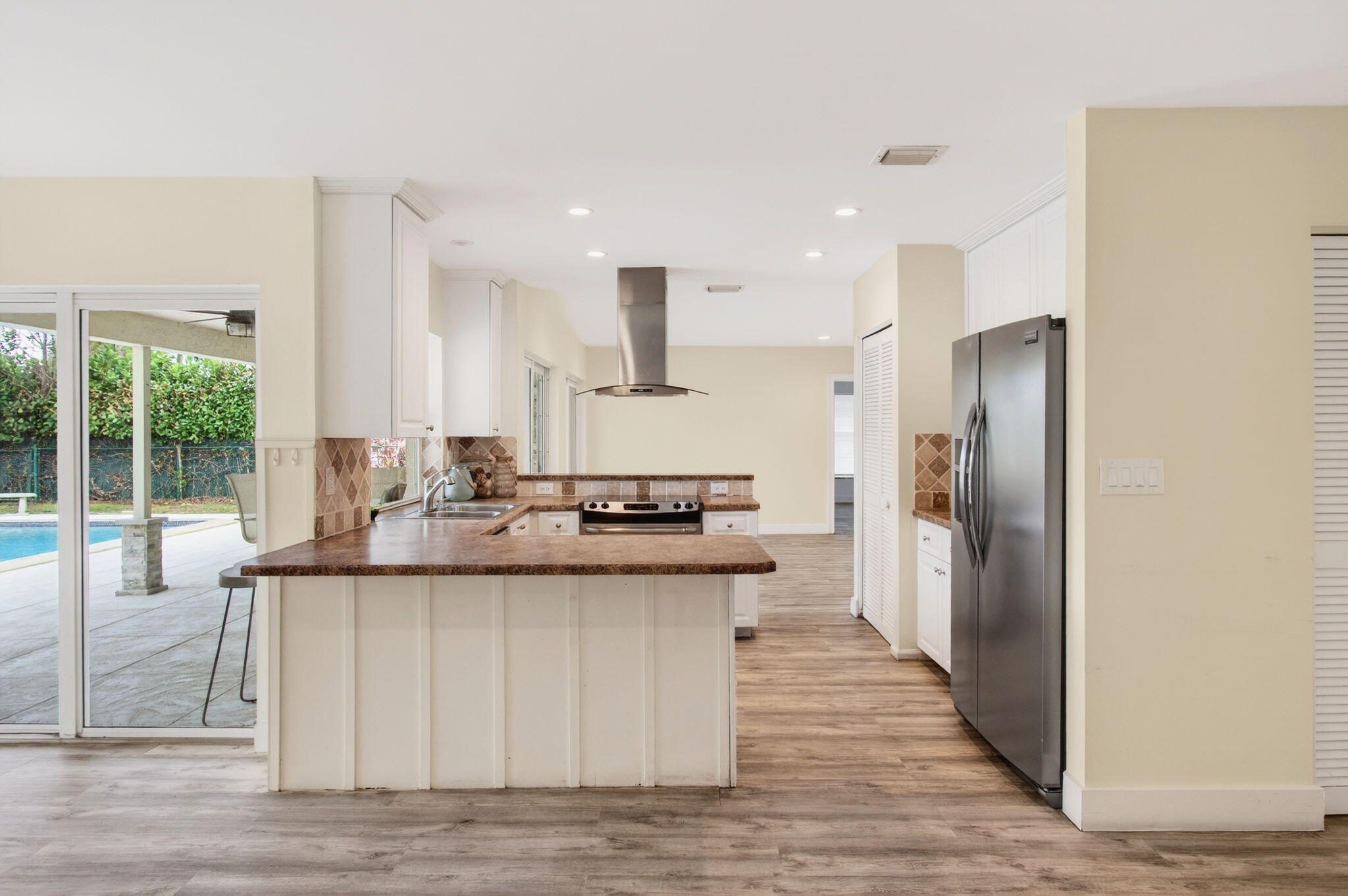 6063 Golf Vista Way Boca Raton, FL 33433 - Photo 15 of 52 a kitchen with stainless steel appliances granite countertop a sink and a refrigerator