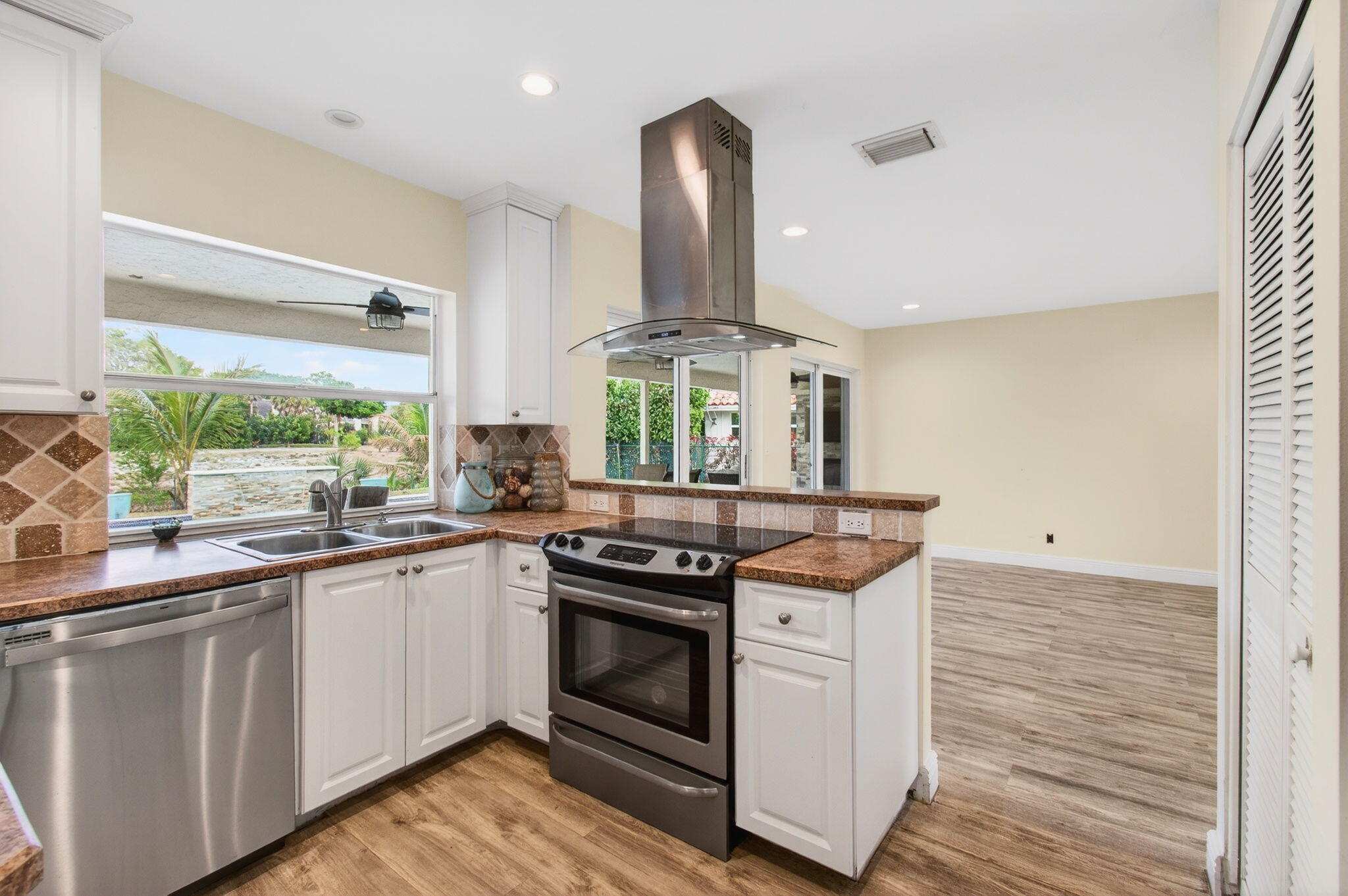 6063 Golf Vista Way Boca Raton, FL 33433 - Photo 17 of 52 a kitchen with stainless steel appliances granite countertop a stove and a sink