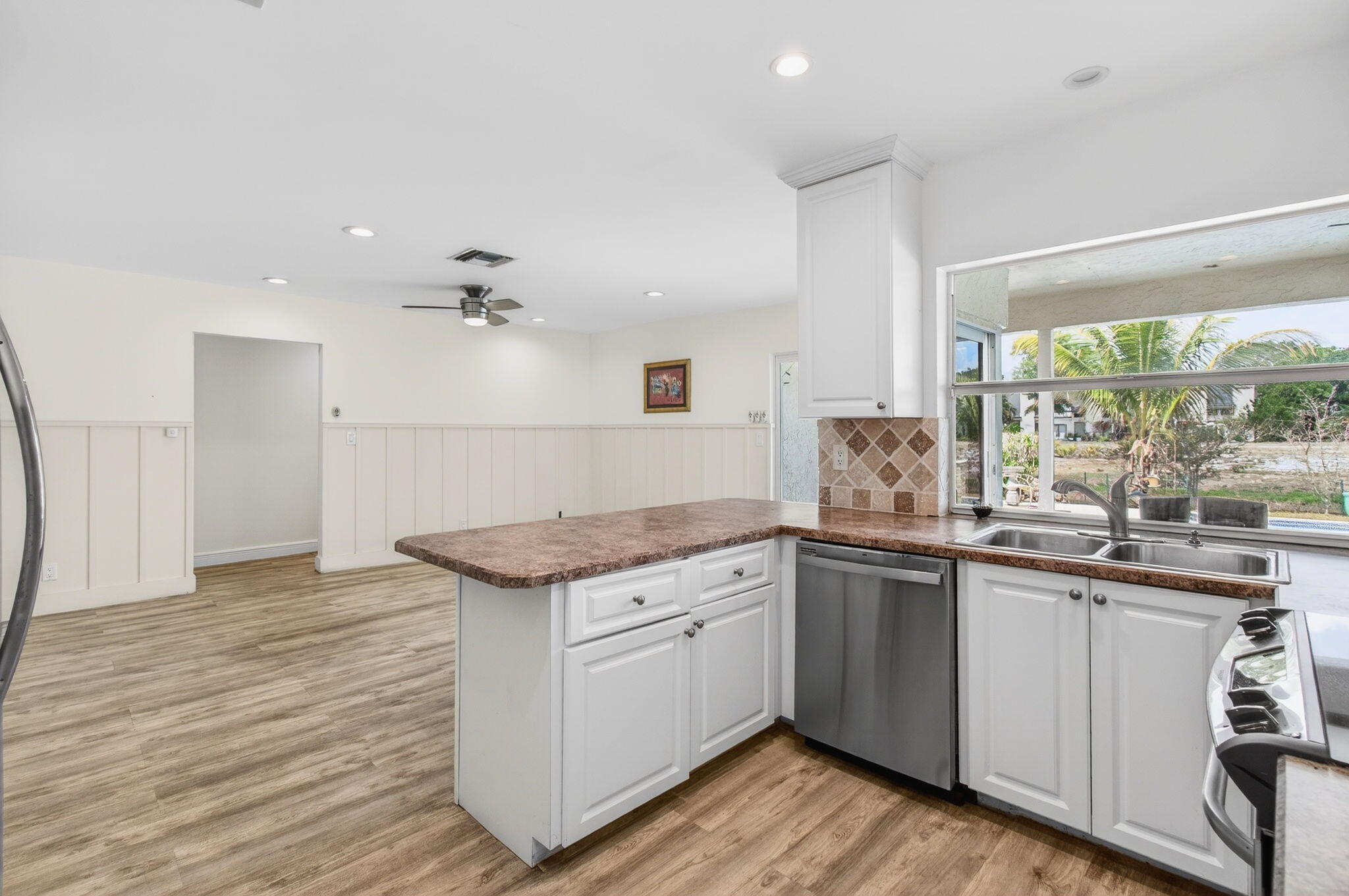 6063 Golf Vista Way Boca Raton, FL 33433 - Photo 18 of 52 a kitchen with granite countertop white cabinets and white appliances