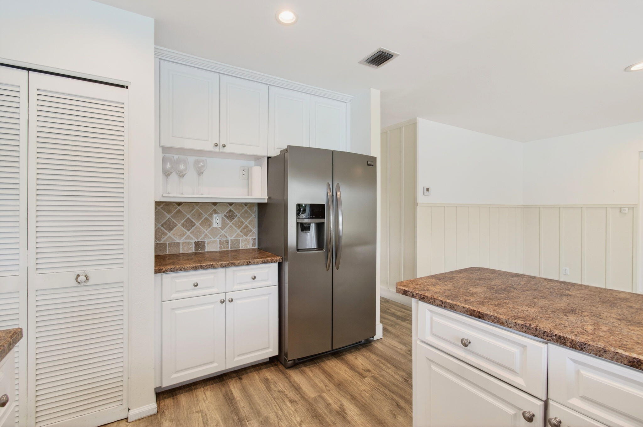 6063 Golf Vista Way Boca Raton, FL 33433 - Photo 19 of 52 a kitchen with granite countertop a refrigerator and cabinets