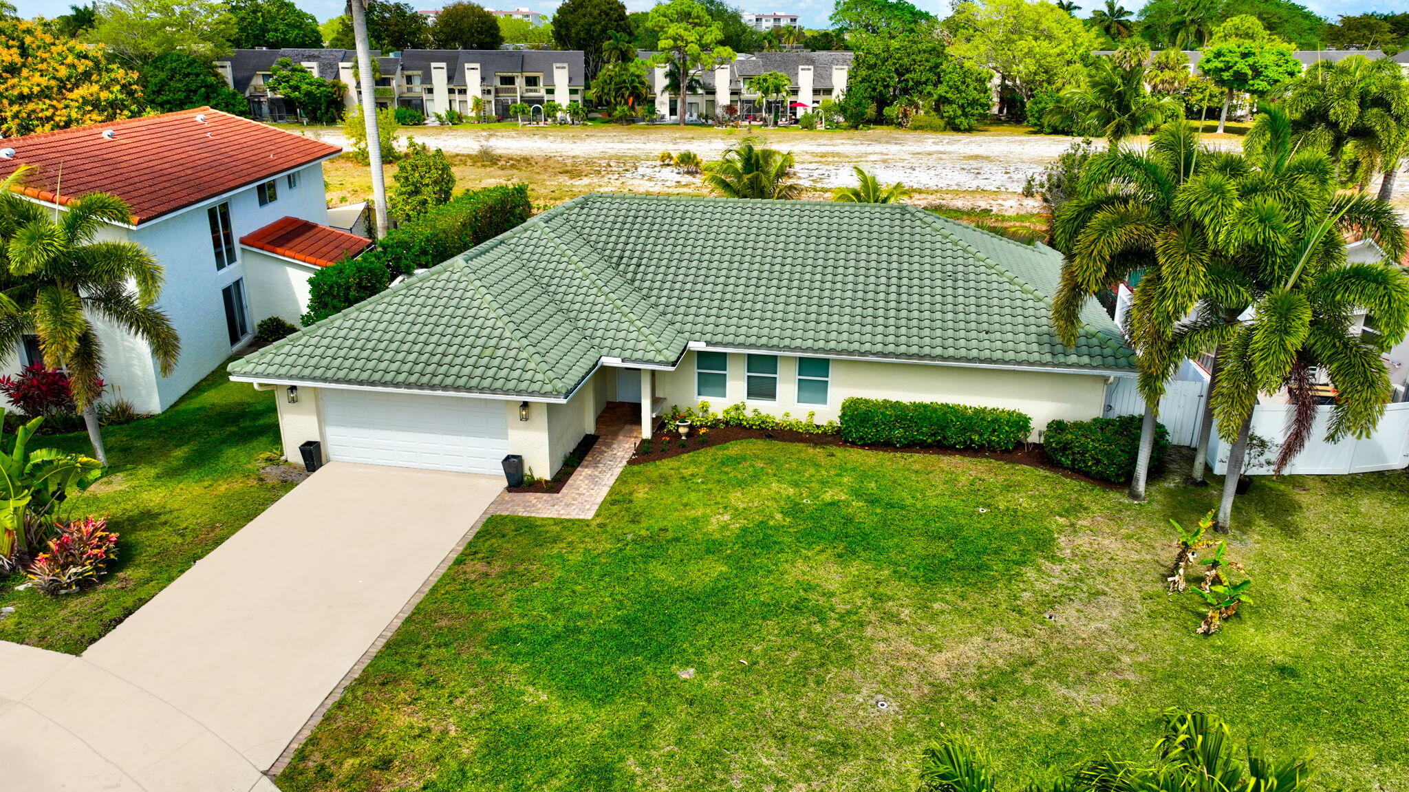 6063 Golf Vista Way Boca Raton, FL 33433 - Photo 2 of 52 a view of a house with a yard