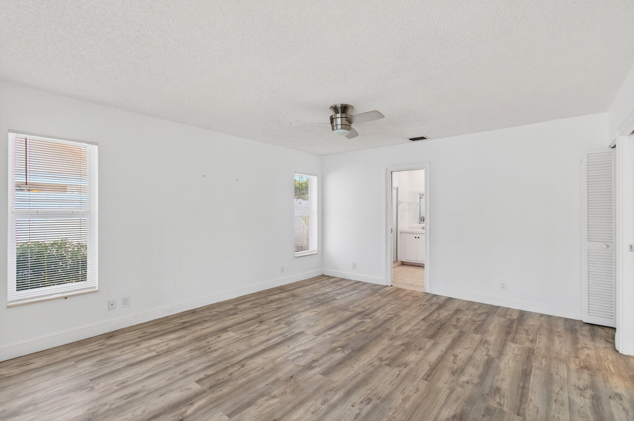 6063 Golf Vista Way Boca Raton, FL 33433 - Photo 25 of 52 wooden floor in an empty room with a window