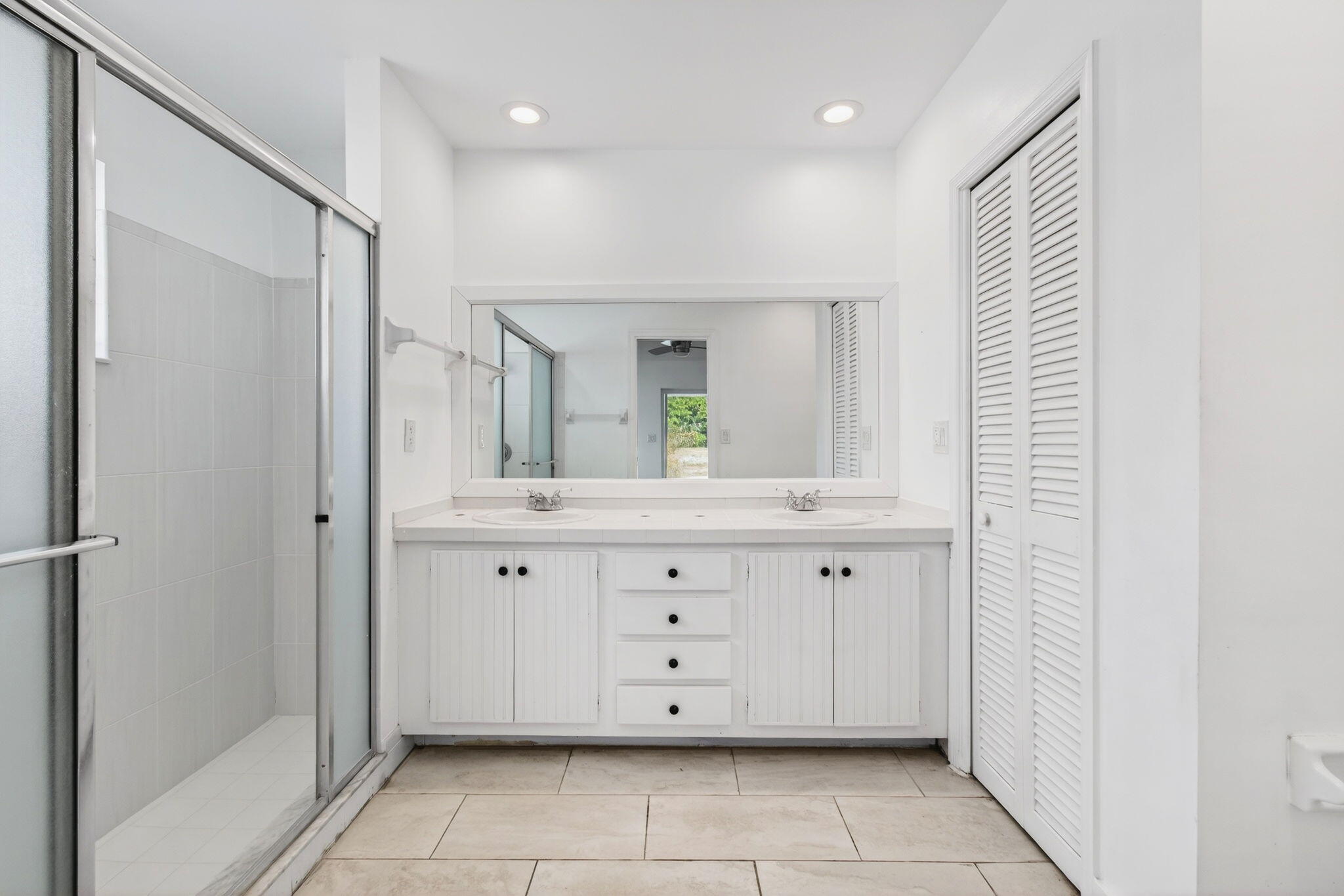 6063 Golf Vista Way Boca Raton, FL 33433 - Photo 26 of 52 a spacious bathroom with a double vanity sink mirror and