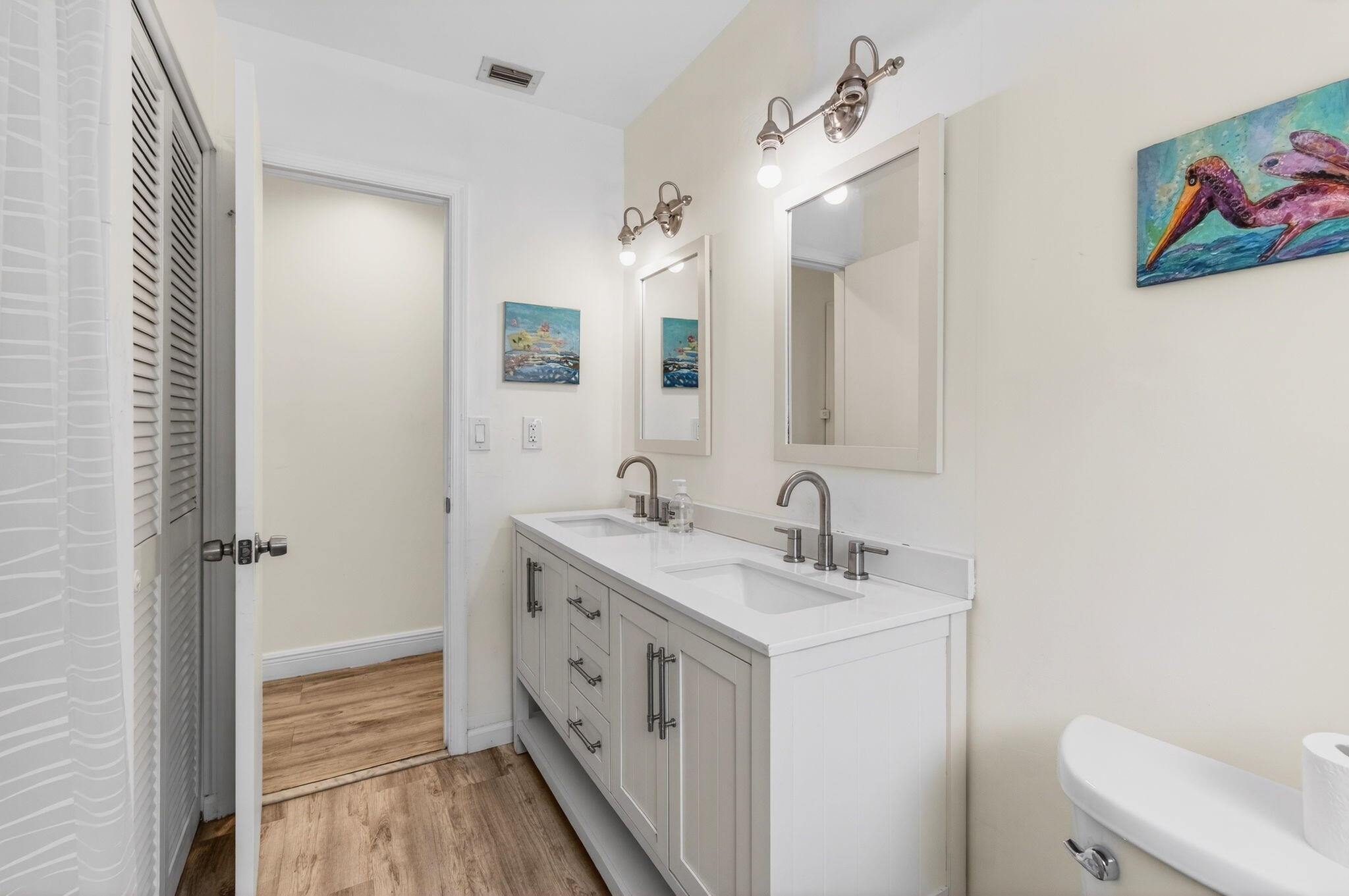 6063 Golf Vista Way Boca Raton, FL 33433 - Photo 34 of 52 a spacious bathroom with a double vanity sink toilet and a mirror