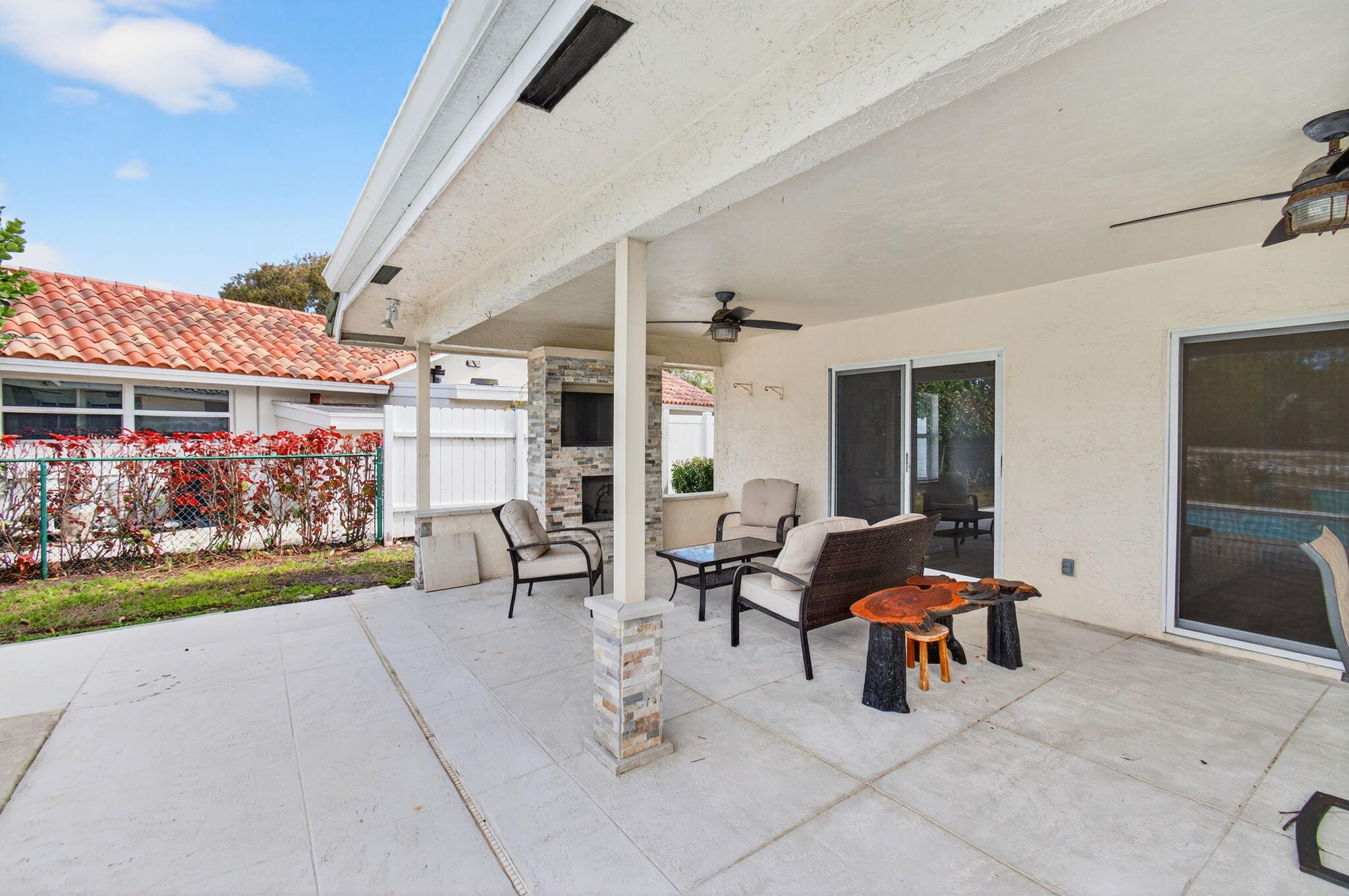 6063 Golf Vista Way Boca Raton, FL 33433 - Photo 41 of 52 a view of a patio with dining table and chairs with plants and a yard